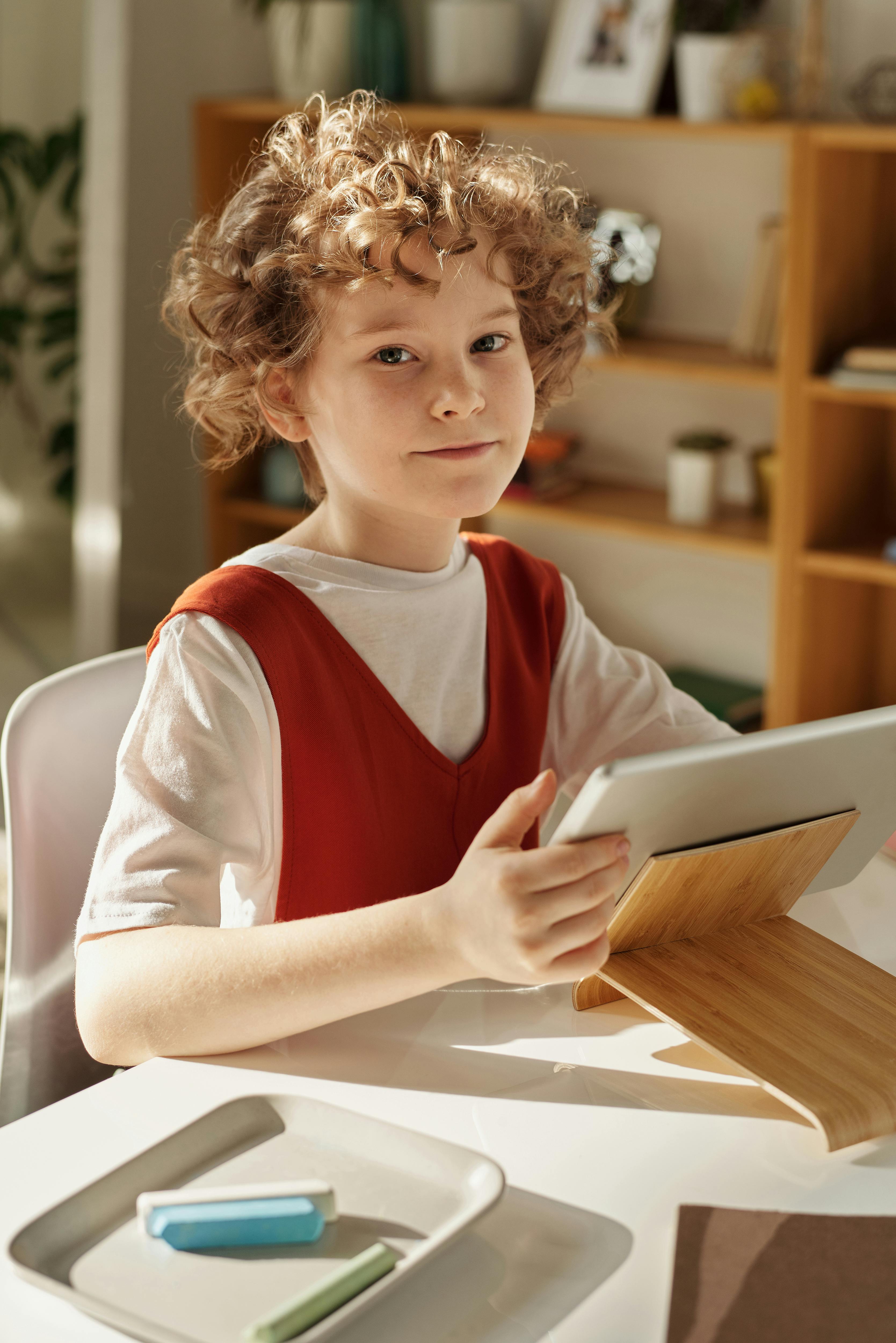 Primary school child learning online under adult supervision – promoting online safety in line with KCSIE 2025 guidance